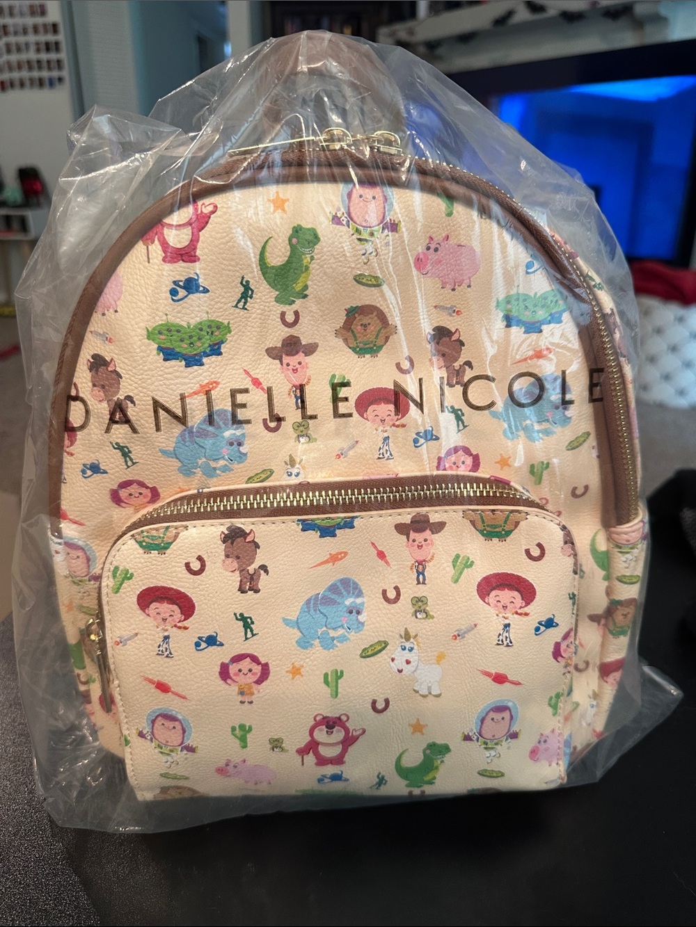 Danielle Nicole Cream Toy Story Character Mini Backpack with Gold Trim